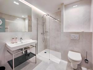 a bathroom with a shower and a sink and a toilet at Aparthotel AMMI Nice Lafayette in Nice