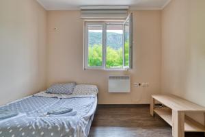 a bedroom with two beds and a window at Guest House Jovana in Kotor