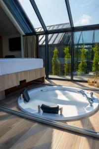 a bath tub in a room with a large window at Woodlife Bungalov in Ardeşen