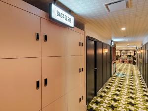 a hallway with lockers and a sign on the wall at Aparthotel AMMI Nice Lafayette in Nice