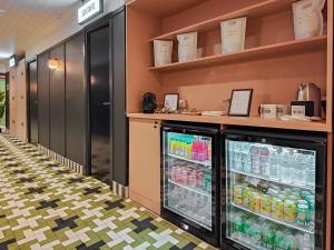 a cafeteria with a refrigerator with drinks in it at Aparthotel AMMI Nice Lafayette in Nice