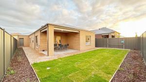 a house with a lawn in front of it at The Grove Townhouse by GoodLive in Tarneit