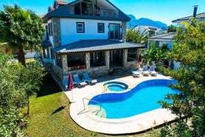 an aerial view of a house with a swimming pool at mountain view Villa Zuhal Dalyan in Ortaca