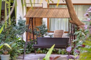 a chair in a swing in a garden at Hotel Ranthambore Regency in Sawāi Mādhopur