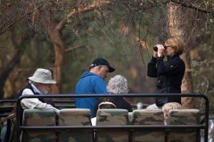 a woman taking a picture of people on a bus at Hotel Ranthambore Regency in Sawāi Mādhopur