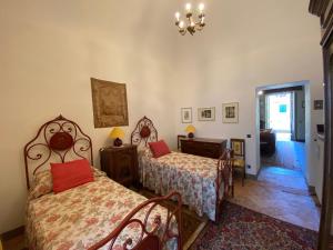 Postel nebo postele na pokoji v ubytování Palazzo Ronchelli