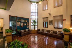 a living room with couches and a large window at Hotel Ranthambore Regency in Sawāi Mādhopur