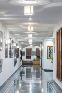 a hallway in a building with a lobby with art on the walls at Hotel Ranthambore Regency in Sawāi Mādhopur