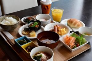 a tray with various dishes of food on a table at Daiwa Roynet Hotel Koriyama Ekimae in Koriyama