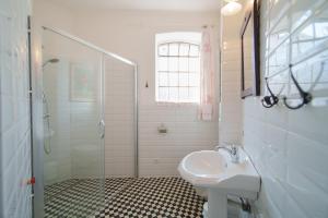 a white bathroom with a sink and a shower at Historic Farmhouse Kojetice in Kojetice