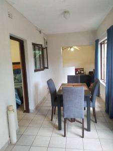 a dining room with a table and chairs at Lethabo Self-Catering Apartment 2 in Margate
