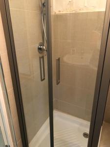 a shower with a glass door in a bathroom at casa gramazio in Manfredonia