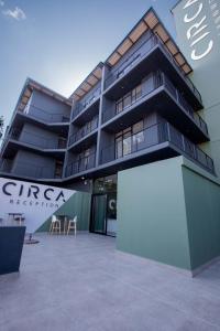 a building with a white sign in front of it at Circa Aparthotel by Totalstay in Pretoria