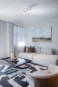 a living room with a couch and a coffee table at Circa Aparthotel by Totalstay in Pretoria