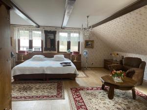 a bedroom with a bed and a couch and a table at Orle Gniazdo Orło in Ryn