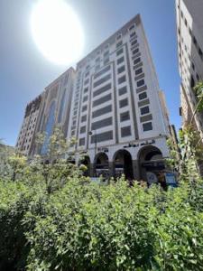 a large white building with trees in front of it at Mysk Touch Al Balad in Al Madinah