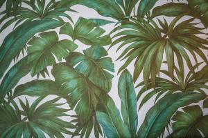 a wallpaper with green palm leaves on a wall at Gaby Lake Suites in Como