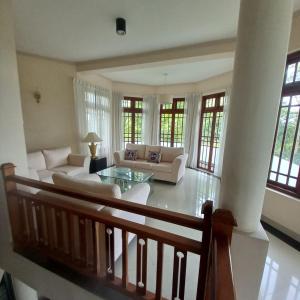 a large living room with white furniture and windows at Crown hills kandy in Kandy