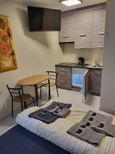 a kitchen with a bed and a table and chairs at 7 Mila Pokoje Kutno in Kutno