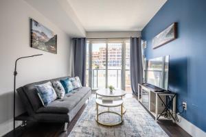 a living room with a couch and a table at Beautiful Condos In the Heart of Downtown by GLOBALSTAY in Toronto
