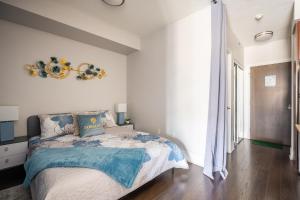 a bedroom with a bed and a large window at Beautiful Condos In the Heart of Downtown by GLOBALSTAY in Toronto