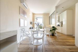 a kitchen and dining room with a table and chairs at Apartment Novolino With Balcony in Florence