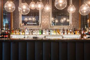 a bar with lots of bottles of alcohol and lights at Premier Inn Wuppertal City Centre in Wuppertal