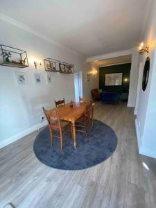 a dining room with a wooden table and chairs at Auret Street Garden Cottage in Paarl