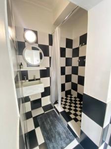 a bathroom with a black and white checkered floor at Auret Street Garden Cottage in Paarl