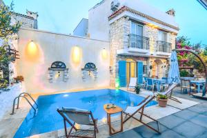 a villa with a swimming pool and a house at Alacati Asmali Konak Hotel in Alacati