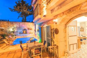 a house with a swimming pool in front of a building at Alacati Asmali Konak Hotel in Alaçatı