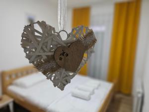 a bunch of hearts hanging on a bed at AL Apartments 02 in Prizren