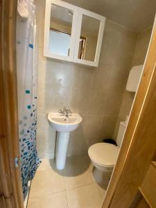a bathroom with a toilet and a sink at Studio to let in Covent Garden with kitchen in London
