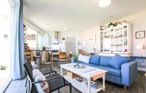 a living room with a blue couch and a table at Awesome Apartment In Sete With Wifi in Sète