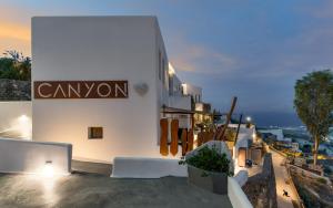 a building with a sign on the side of it at Canyon Santorini in Fira