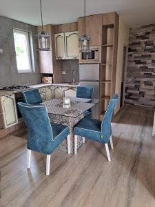 a kitchen with a table and chairs in a kitchen at Todea House in Reghin