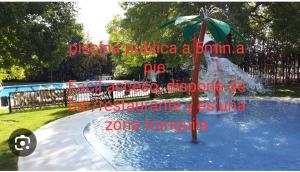 a fountain with an umbrella in the middle of a pool at Apartamento la alberca 3 in Aracena