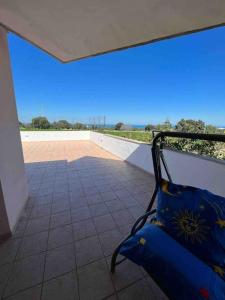 a blue suitcase is sitting on a balcony at Fusella Country House/Villa a Polignano Vista Mare in Polignano a Mare