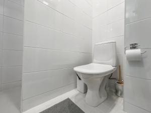 uma casa de banho branca com um WC e um rolo de papel higiénico em Residential Hotels Helsinki Penthouse em Helsínquia