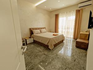 1 dormitorio con cama y ventana en Matteo's Apartments en Velipojë