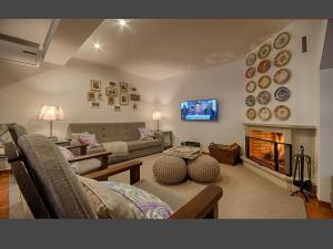 a living room with a couch and a fireplace at Casa da Costa in Melgaço