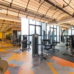 a gym with treadmills and chairs in a building at Infinity Pool Scarletz Suites KLCC in Kuala Lumpur