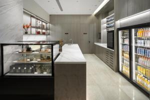 a kitchen with a counter and a drink refrigerator at Hyatt Place Linyi People Square in Linyi