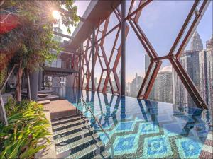 a view from the top of a building with a swimming pool at Infinity Pool Scarletz Suites KLCC in Kuala Lumpur