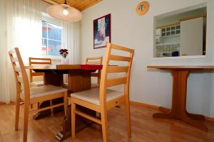 a dining room with a wooden table and chairs at Ferienwohnung Nagoldtalblick in Nagold