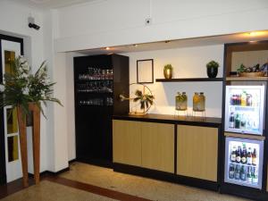 a bar in a room with a refrigerator at Tulip Inn Heerlen City Centre in Heerlen