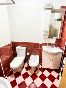 a bathroom with a toilet and a sink at Boba’s apartment in Durrës