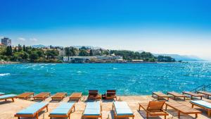 a group of beach chairs and a body of water at Urban Chic LUXE apartments near Beach Bačvice & CENTRE in Split