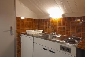 a kitchen with a sink and a counter top at Studio in the center of the village in La Clusaz