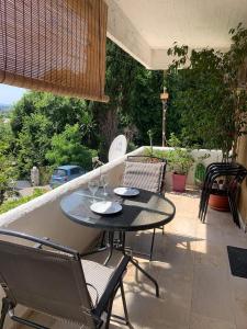 a table and chairs sitting on a patio at Corfu town Kanoni apartment in Corfu